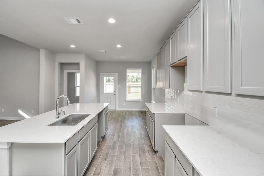 Discover another perspective of this exquisite kitchen, lavishly furnished with an ample expanse of counter space, offering tons of room for culinary creativity. Sample photo of completed home with similar floor plan. Actual colors and selections may vary. Discover another perspective of this exquisite kitchen, lavishly furnished with an ample expanse of counter space, offering tons of room for culinary creativity. Sample photo of completed home with similar floor plan. Actual colors and selections may vary.