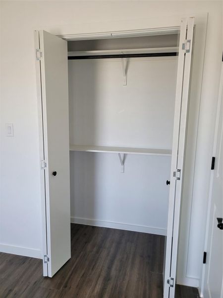 Ample storage solutions feature a built-in shelf and hanging rod for organized living. Ample storage solutions feature a built-in shelf and hanging rod for organized living.