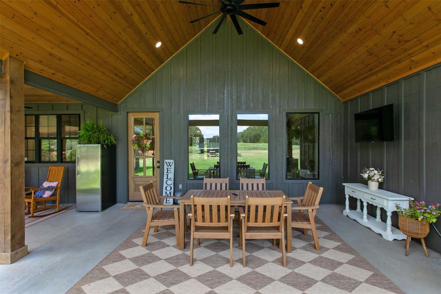 View of patio with ceiling fan and outdoor dining space