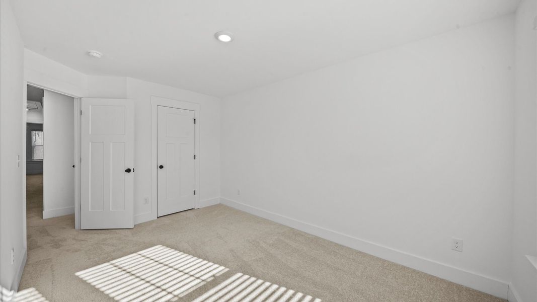 Memorable space with walk-in closet, soft carpeting, and striking natural light from large windows at Clayton Crossing