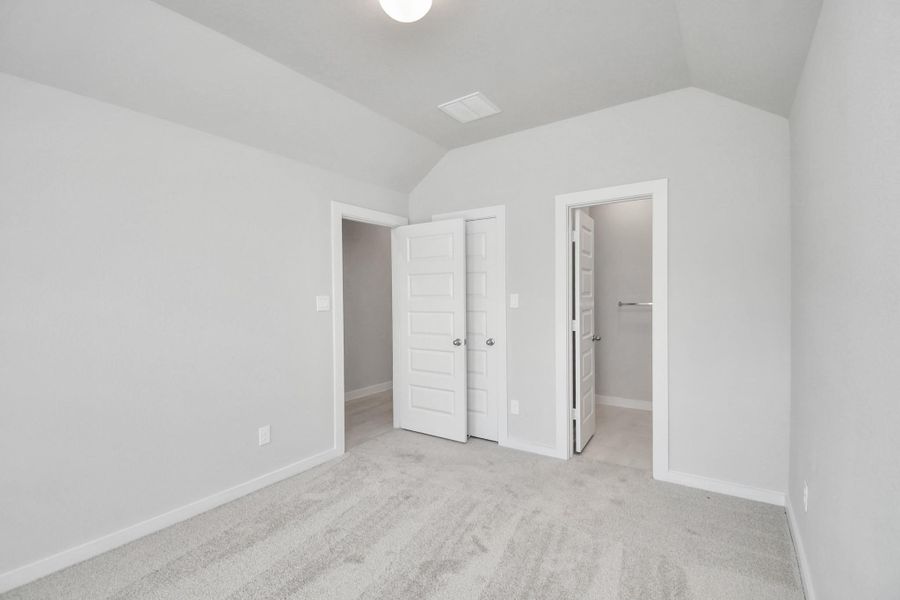 Generously sized secondary bedrooms featuring spacious closets, soft and inviting carpeting underfoot, large windows allowing plenty of natural light, and the added touch of privacy blinds for your personal retreat. Sample photo of completed home with similar floor plan. Actual colors and selections may vary.