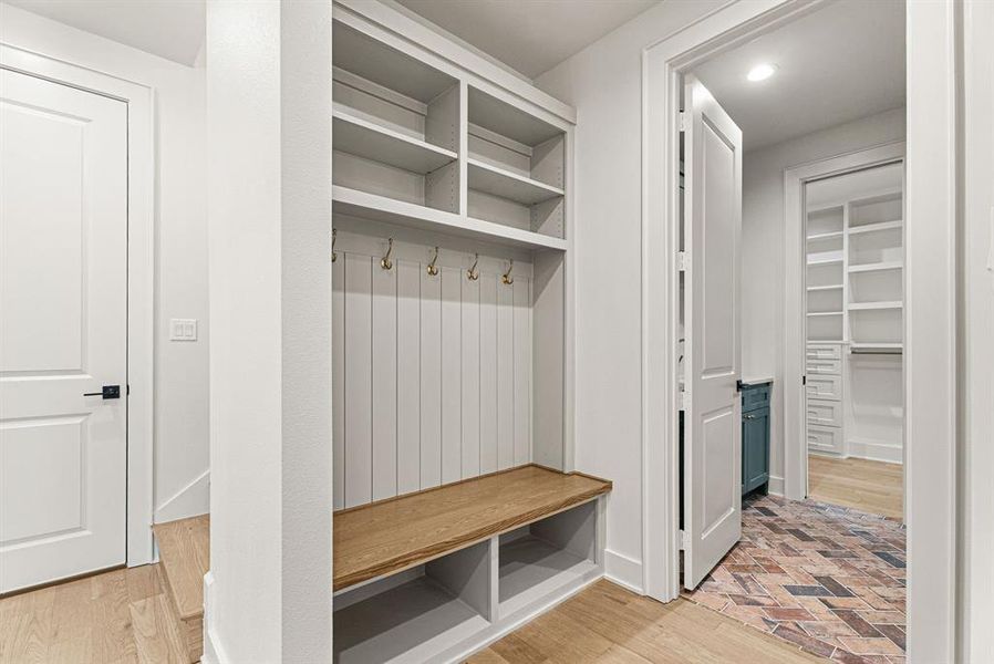 Mudroom featuring light wood-type flooring and baseboards