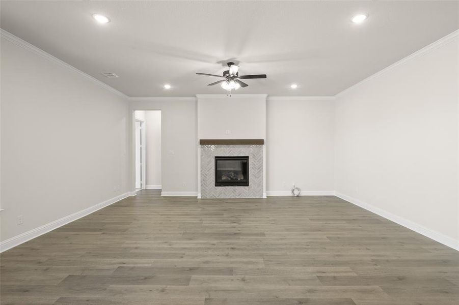 Living room featuring a fireplace with tile around and a Mantle.