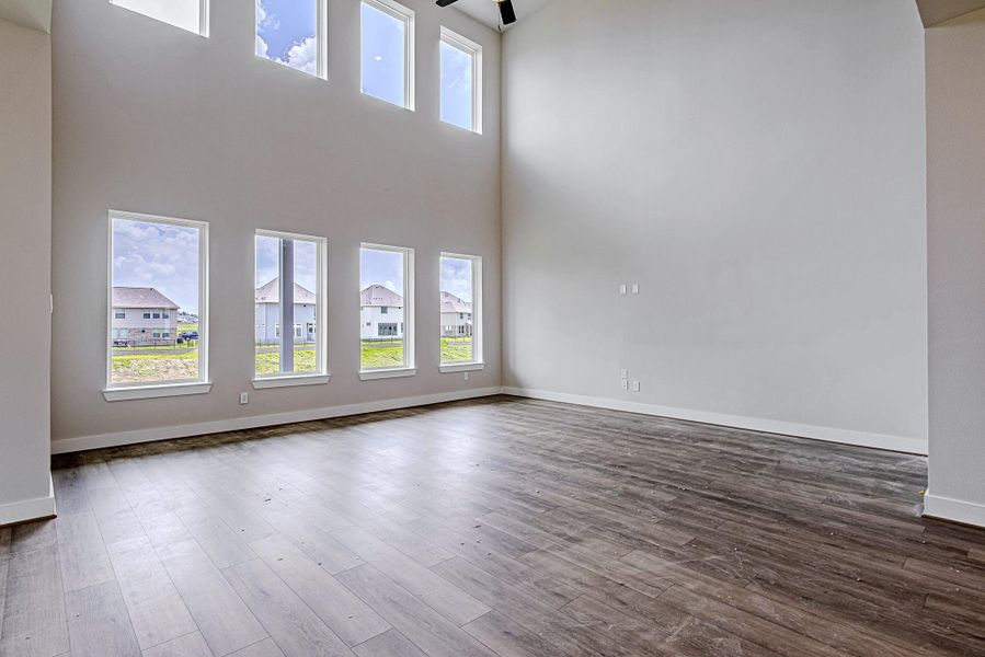 Expansive family room with dramatic ceilings and oversized windows Expansive family room with dramatic ceilings and oversized windows