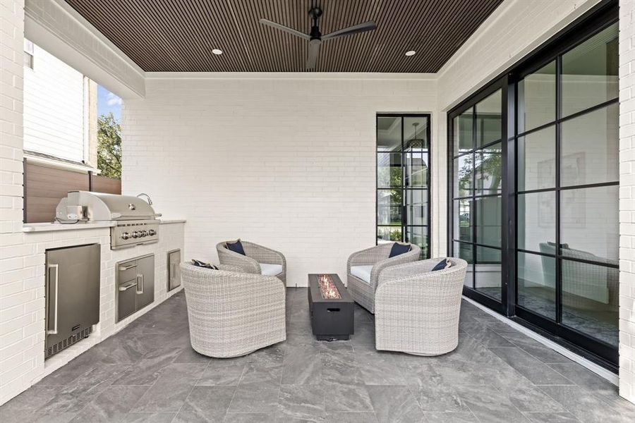 View of patio with exterior kitchen, ceiling fan, and outdoor lounge area View of patio with exterior kitchen, ceiling fan, and outdoor lounge area