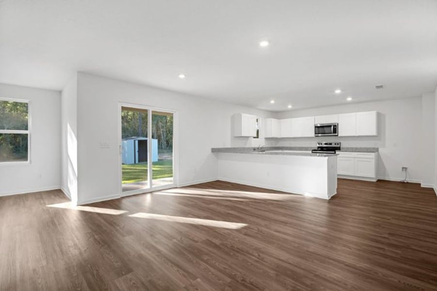 A large kitchen with white cabinets. A large kitchen with white cabinets.