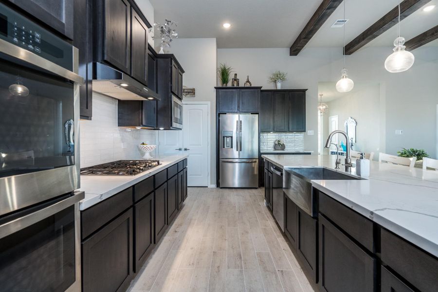 GE Profile stainless steel double ovens and cooktop.