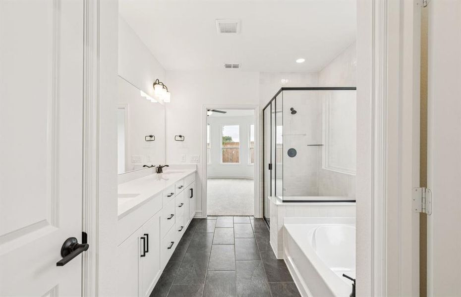 Luxurious owner's bath complete with double sinks and a generous shower  *Real home pictured