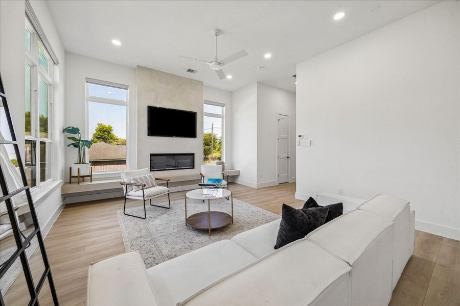 Soft Scandinavian influences come to life through the textured fireplace surround, wide plank flooring, and thoughtfully curated designer finishes.