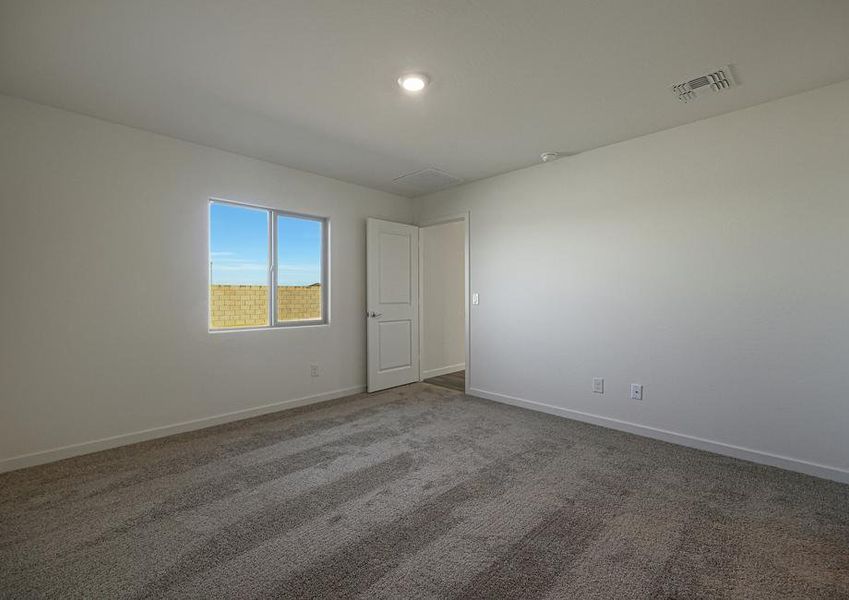 The master suite of this home has plenty of space for your king-sized furniture.