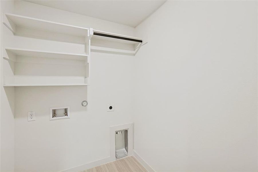 Clothes washing area with gas dryer hookup, light hardwood / wood-style flooring, washer hookup, and electric dryer hookup