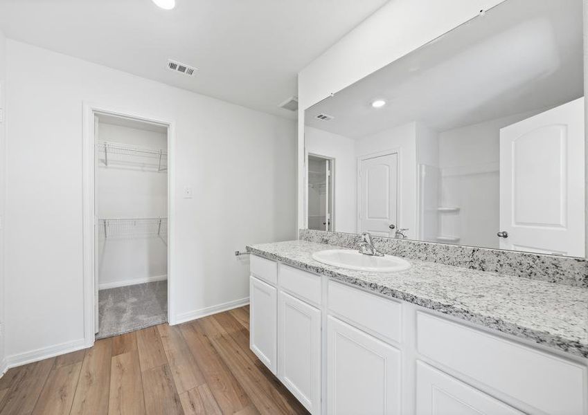 The master bathroom has a long vanity perfect for additional space.