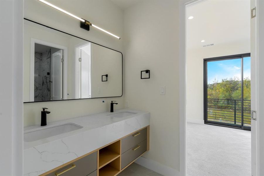 Jack & Jill Bathroom with double vanity, light carpet, and recessed lighting