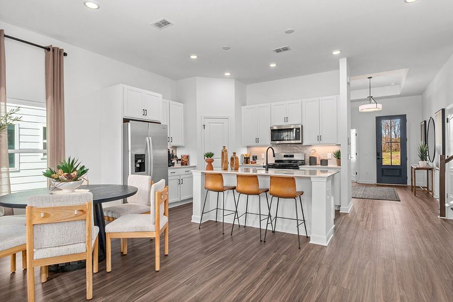 A kitchen with a wood floor.