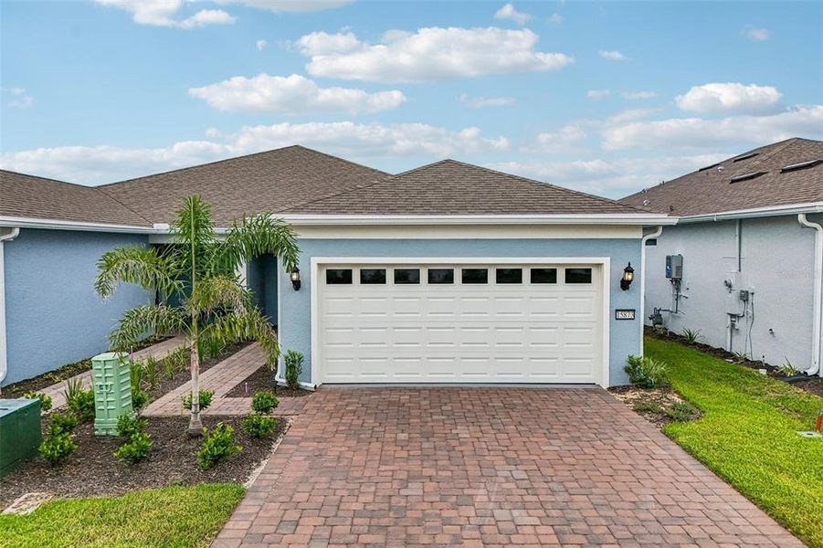 Front exterior of a new home in Del Webb Oasis, Winter Garden, FL, highlighting curb appeal (Image 24). Front exterior of a new home in Del Webb Oasis, Winter Garden, FL, highlighting curb appeal (Image 24).
