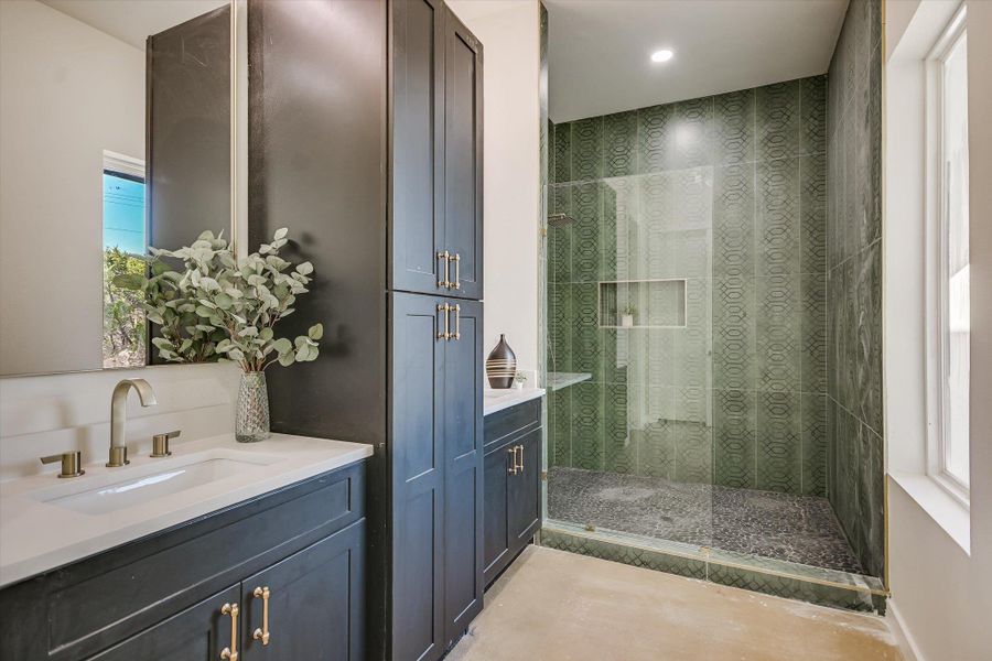 Full bath featuring vanity and a tile shower
