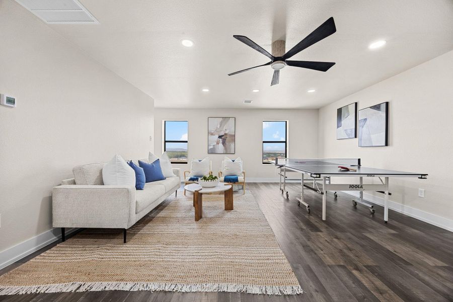 Rec room with dark wood finished floors, recessed lighting, and a ceiling fan Rec room with dark wood finished floors, recessed lighting, and a ceiling fan