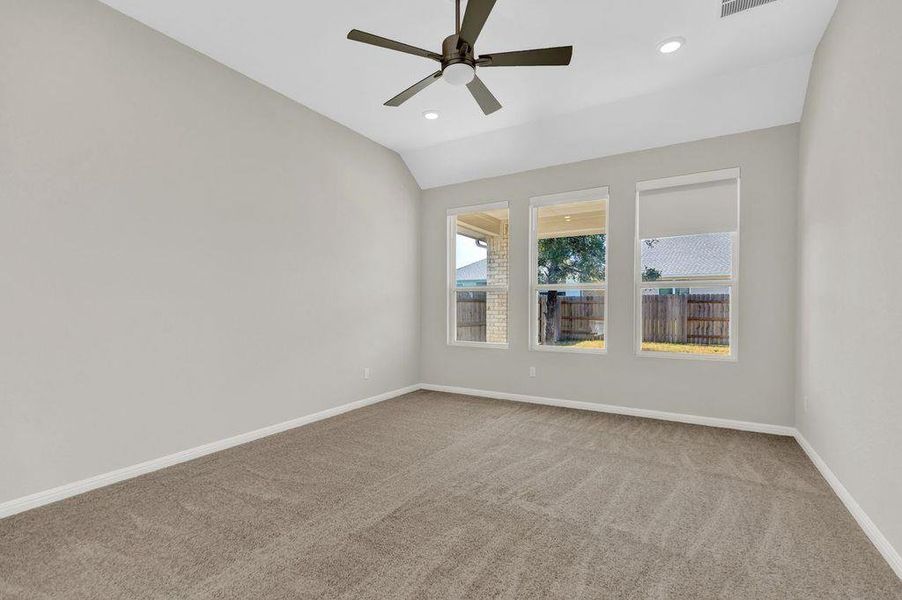 Unfurnished room with light colored carpet, recessed lighting, lofted ceiling, and a ceiling fan Unfurnished room with light colored carpet, recessed lighting, lofted ceiling, and a ceiling fan