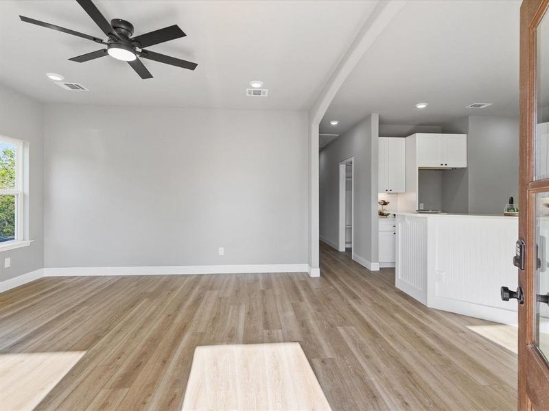 Unfurnished living room with light wood-style floors, recessed lighting, and ceiling fan Unfurnished living room with light wood-style floors, recessed lighting, and ceiling fan