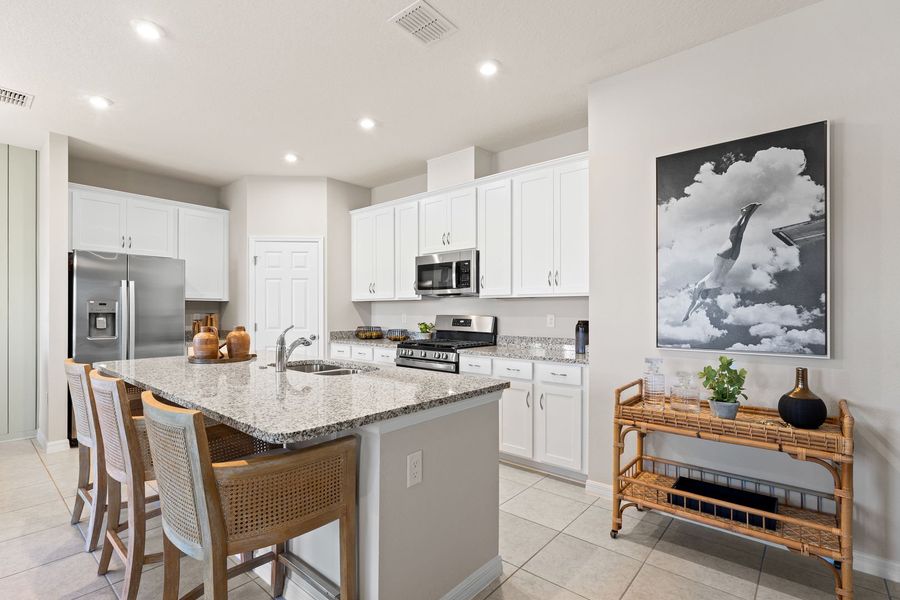 Kitchen with Island Seating of The Juniper at Country Club Estates