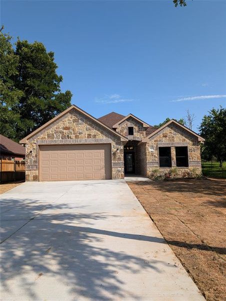 Stone and brick facade with a brown garage door Stone and brick facade with a brown garage door