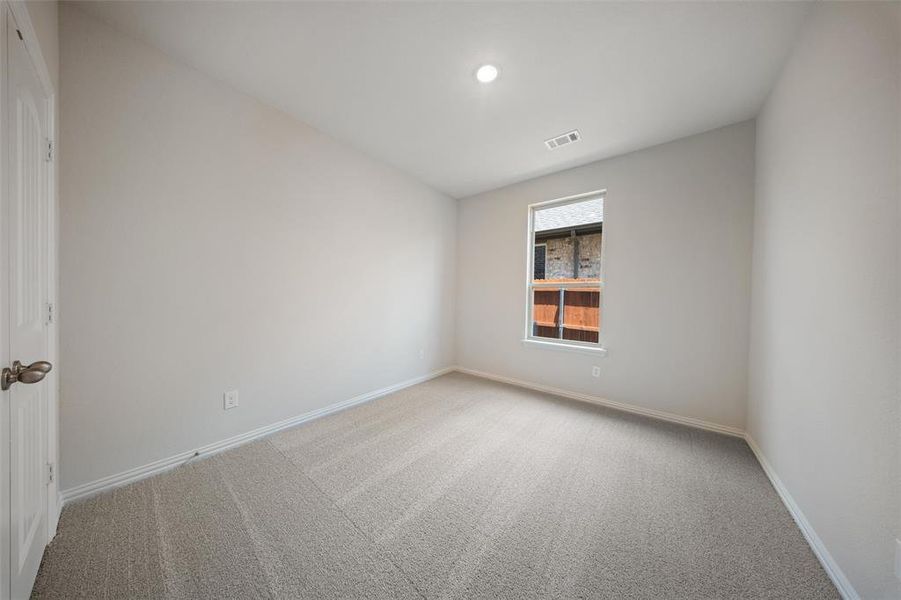 Empty room featuring carpet flooring and baseboards