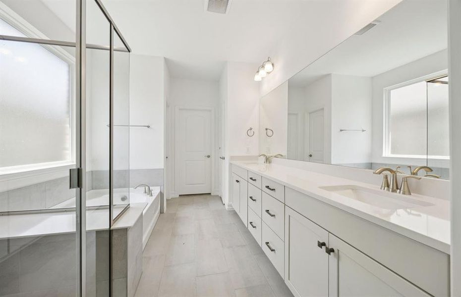 Modern owner's bath with dual vanities and a spacious shower *Real home pictured Modern owner's bath with dual vanities and a spacious shower *Real home pictured