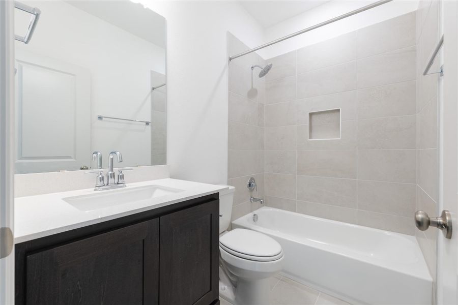 Full bath with vanity, shower / bathtub combination, and light tile patterned floors