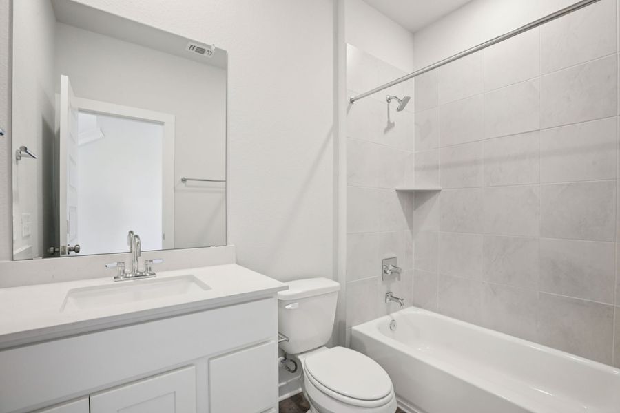 A bathroom with a toilet and sink.