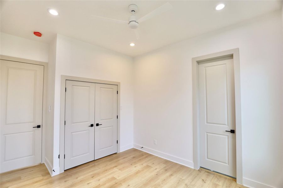 Second bedroom offers a white ceiling fan with a wall mounted remote, two French doors open to your closet. Second bedroom offers a white ceiling fan with a wall mounted remote, two French doors open to your closet.