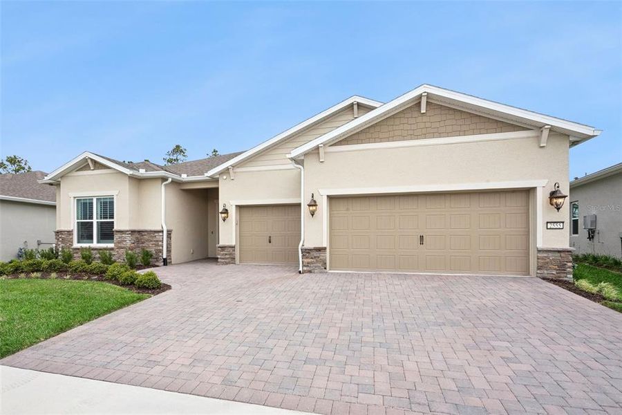 Front exterior of a new home in Del Webb Sunbridge, St. Cloud, FL, highlighting curb appeal (Image 2). Front exterior of a new home in Del Webb Sunbridge, St. Cloud, FL, highlighting curb appeal (Image 2).