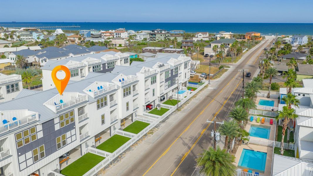 Bird's eye view of a nearby body of water and a pool area Bird's eye view of a nearby body of water and a pool area