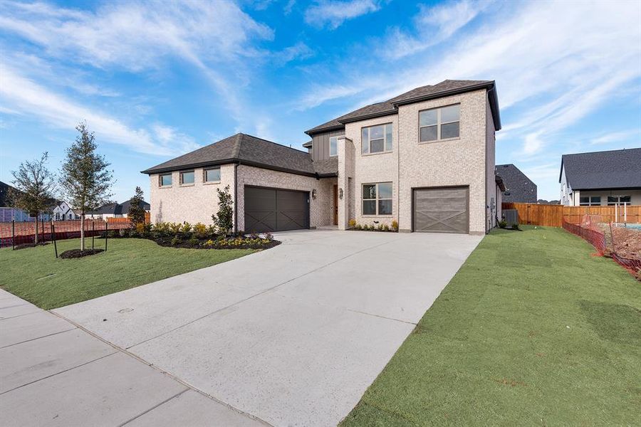 View of front facade featuring driveway, brick siding, a shingled roof, and a garage View of front facade featuring driveway, brick siding, a shingled roof, and a garage