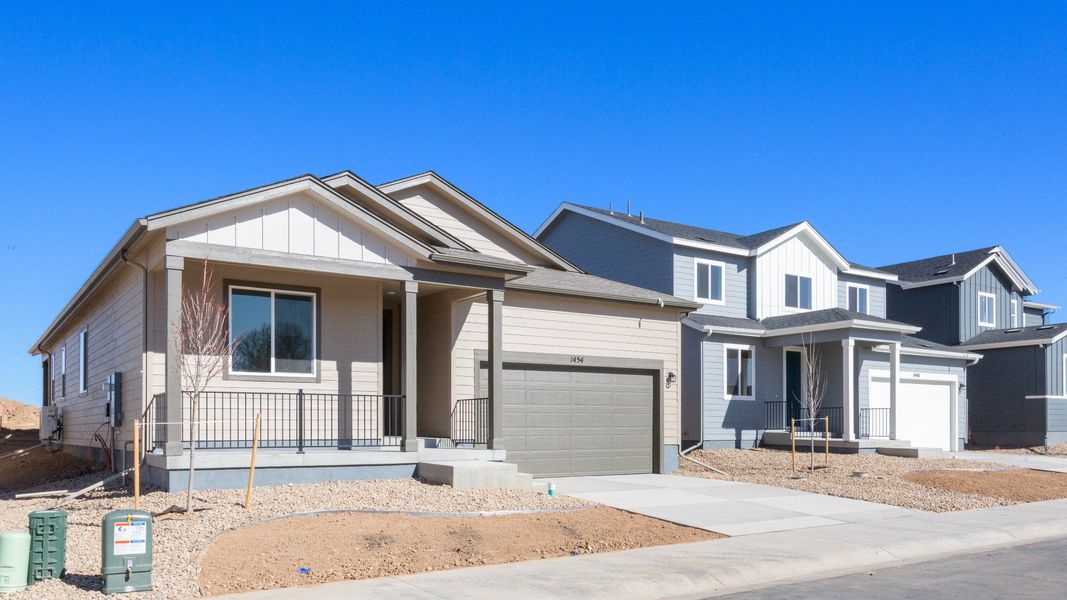Front exterior of a new home in Trevenna, Windsor, CO, highlighting curb appeal (Image 21). Front exterior of a new home in Trevenna, Windsor, CO, highlighting curb appeal (Image 21).