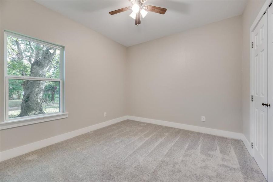 Unfurnished bedroom#2 featuring a closet, carpet, and ceiling fan