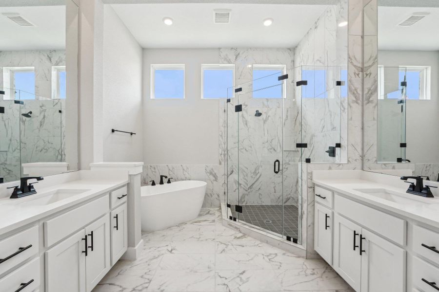 Bathroom with visible vents, a sink, and a marble finish shower Bathroom with visible vents, a sink, and a marble finish shower