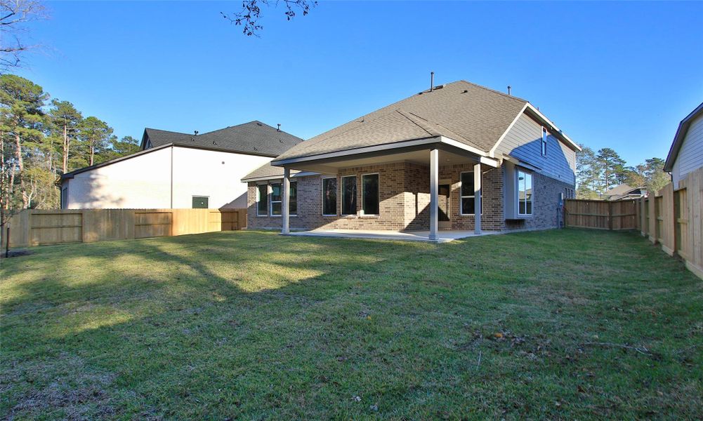 Exterior details and patio area of a home in The Woodlands Hills, Willis (Image 4).