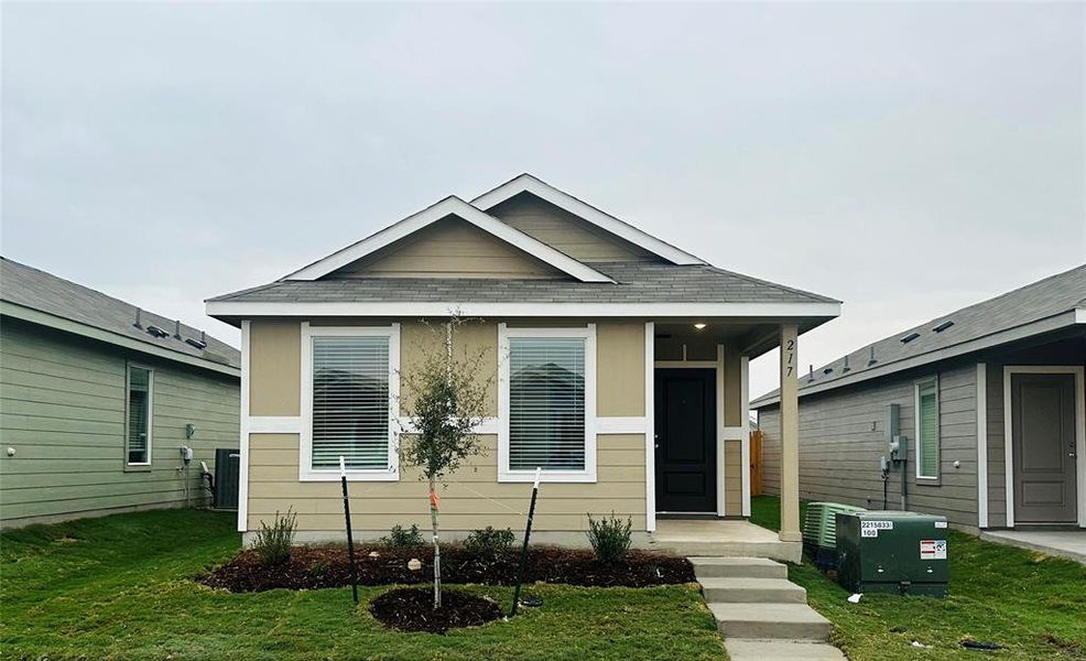 Bungalow-style home with a front lawn