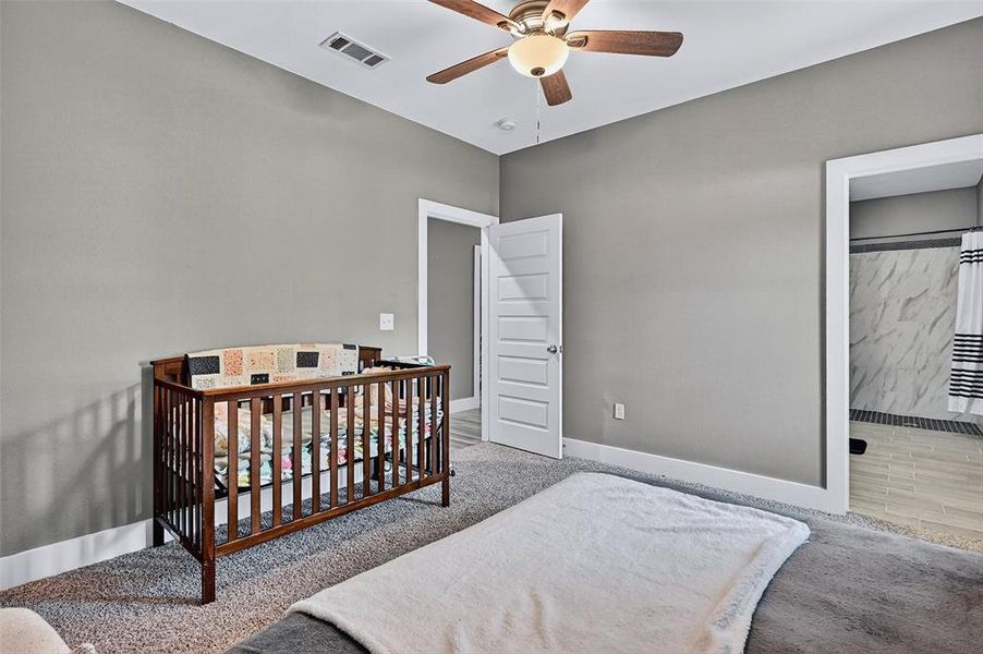Carpeted bedroom featuring baseboards and ceiling fan Carpeted bedroom featuring baseboards and ceiling fan