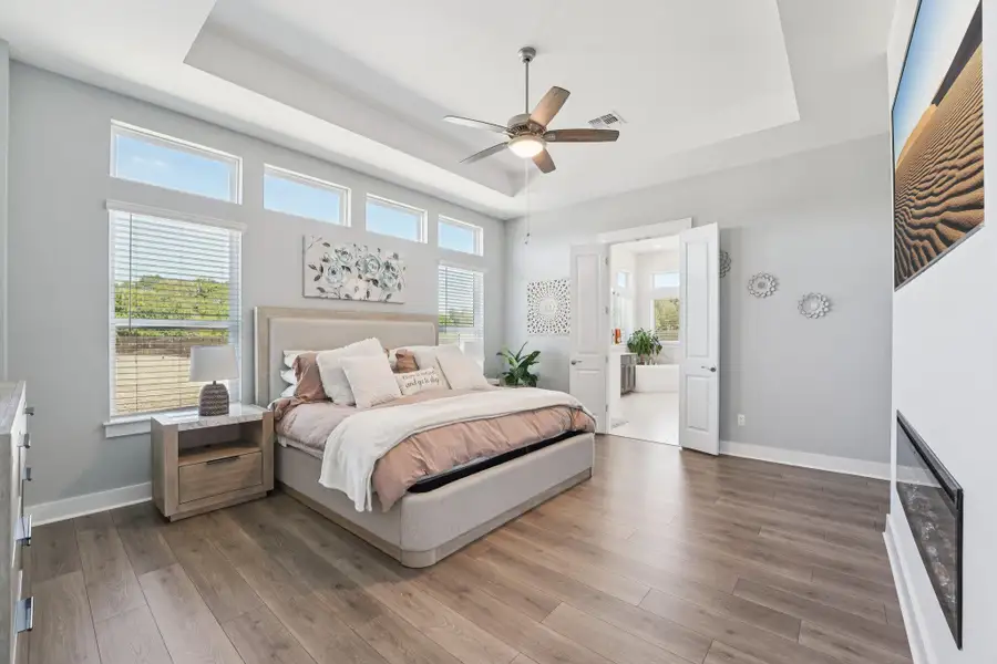 The primary suite is a serene retreat, tucked away for privacy and designed with refined comfort in mind.