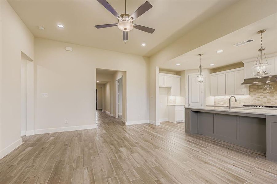 Unfurnished living room with recessed lighting, light wood-type flooring, and a ceiling fan