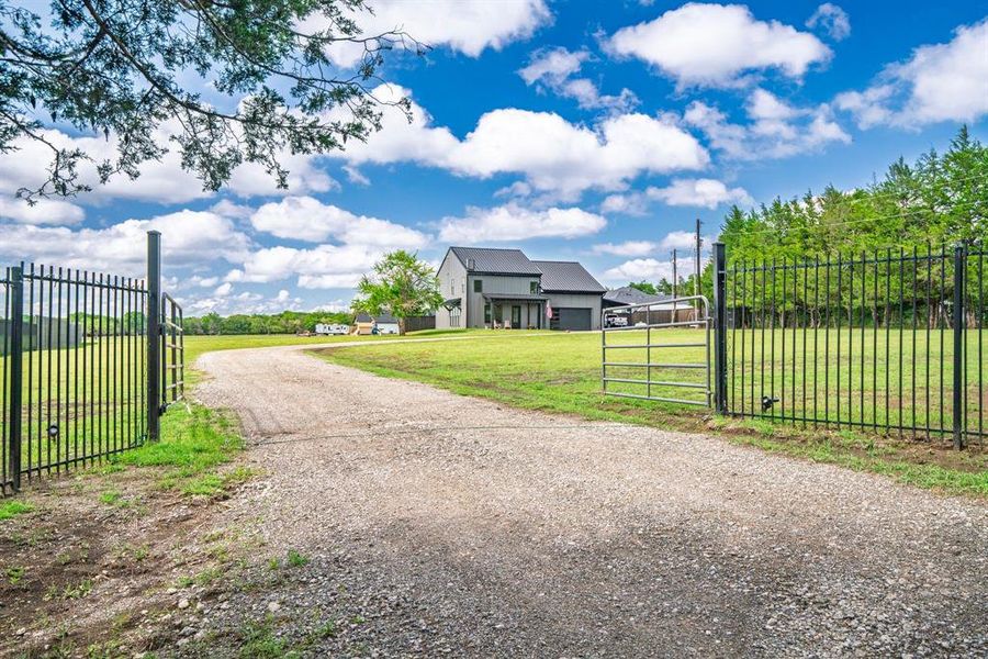 View of dirt / gravel driveway with a gate and a gated entry View of dirt / gravel driveway with a gate and a gated entry