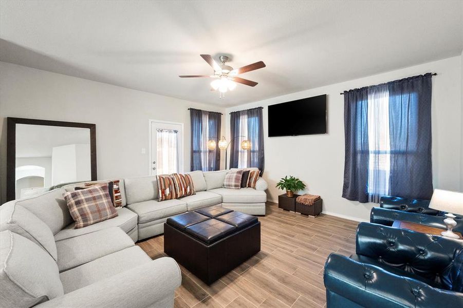 Living room featuring hardwood / wood-style floors and ceiling fan