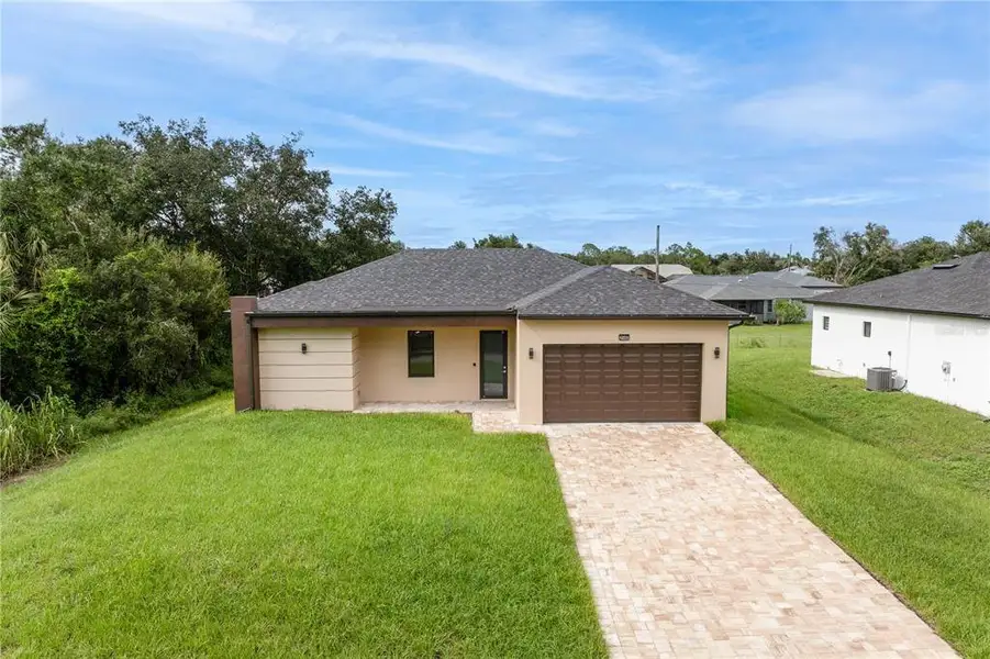 Front exterior of a new home in , Port Charlotte, FL, highlighting curb appeal (Image 2). Front exterior of a new home in , Port Charlotte, FL, highlighting curb appeal (Image 2).