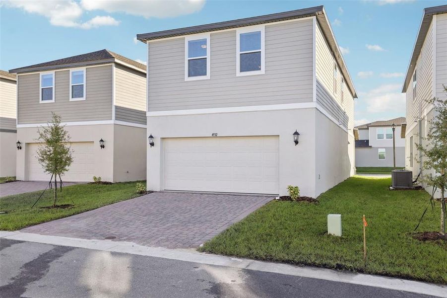 Front exterior of a new home in The Meadow at Crossprairie Bungalows, St. Cloud, FL, highlighting curb appeal (Image 27).