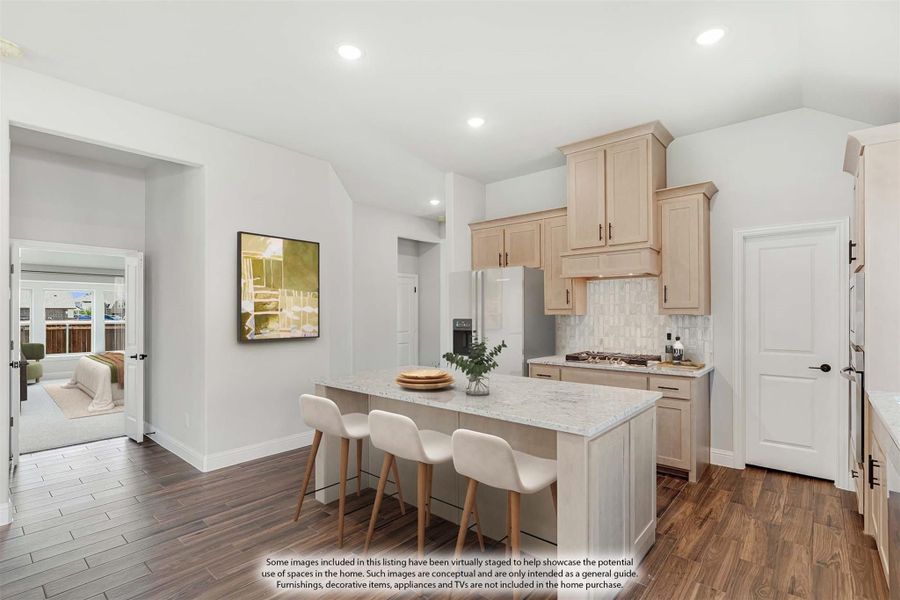 Kitchen with light wood cabinets, marble island with three bar stools, tile backsplash, and dark hardwood floors Kitchen with light wood cabinets, marble island with three bar stools, tile backsplash, and dark hardwood floors