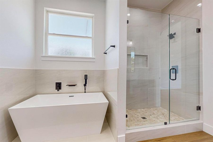 Bathroom featuring separate shower and tub, tile patterned flooring, and tile walls