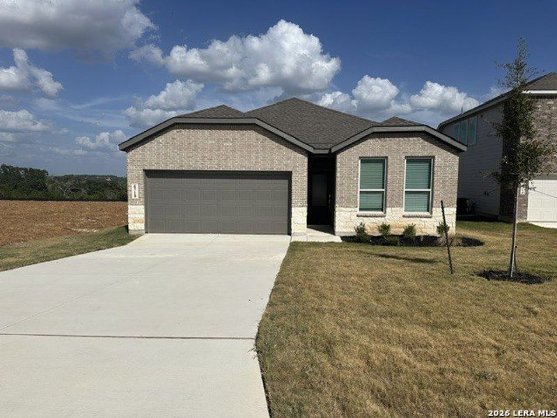 Front exterior of a new home in Juniper Ranch, Spring Branch, TX, highlighting curb appeal (Image 1). Front exterior of a new home in Juniper Ranch, Spring Branch, TX, highlighting curb appeal (Image 1).