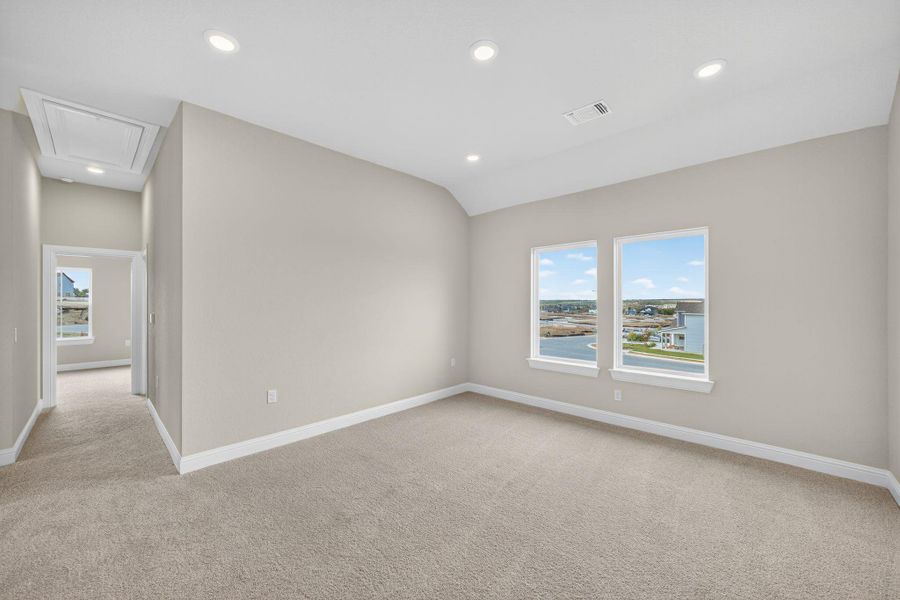 Empty room featuring attic access, plenty of natural light, light colored carpet, recessed lighting, and lofted ceiling Empty room featuring attic access, plenty of natural light, light colored carpet, recessed lighting, and lofted ceiling