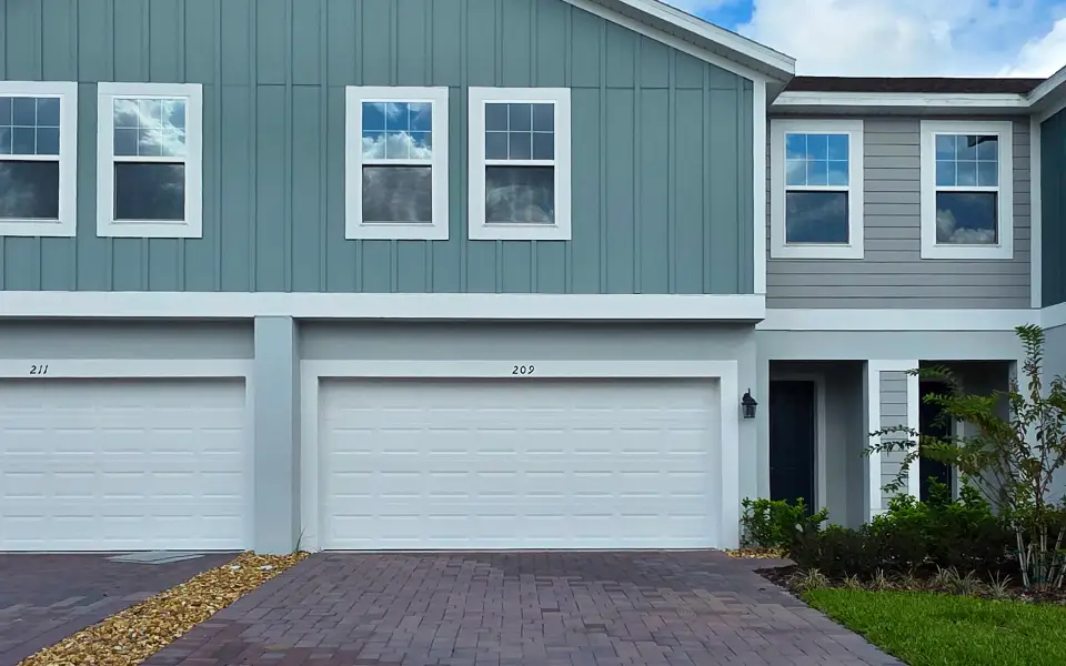 Front exterior of a new home in Blue Springs Reserve Townhomes, Groveland, FL, highlighting curb appeal (Image 2). Front exterior of a new home in Blue Springs Reserve Townhomes, Groveland, FL, highlighting curb appeal (Image 2).